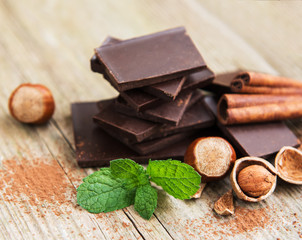 Chocolate with hazelnuts on a old wooden table
