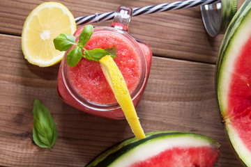 Fresh watermelon smoothie in the mason jar on wooden background. Summer, healthy organic food concept.