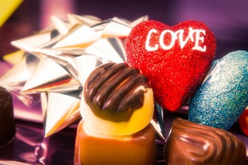 a lot of variety chocolate pralines with colorful hearts