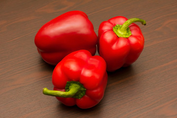 three ripe red peppers