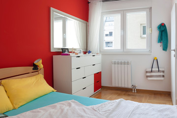 Fototapeta na wymiar Cozy modern colorful bedroom interior with bed sheet