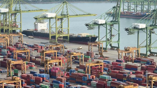 4K Time lapse of crane loading container to cargo ship at port