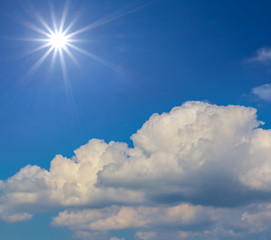 Naklejka na ściany i meble nature background, sparkle sun on a blue sky above a cumulus clouds