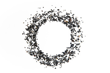 Circle of small black pebbles on white background