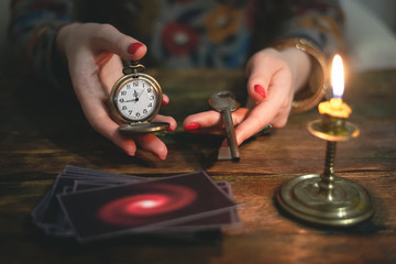 Tarot cards and a woman fortune teller with a unravelling key of fate. Future reading concept....