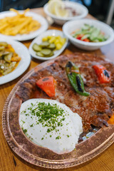 Turkish Doner Kebab, Shawarma or Gyros. Traditional Turkish Doner Kebab meat, iskender, shawarma or gyros with salads in restaurant