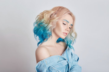 Naklejka premium Portrait woman with bright colored flying hair, all shades purple blue. Hair coloring, beautiful lips and makeup. Hair fluttering in wind. Sexy girl with short hair. Professional creative coloring