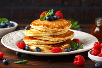 Homemade american blueberry, raspberries pancakes. Healthy morning breakfast. rustic style.