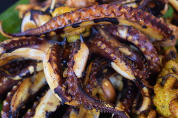Fresh grilled squid on the chatuchak local market in Bangkok, Thailand