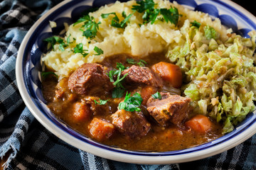 Traditional irish stew served with potatoes and cabbage