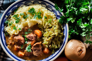 Traditional irish stew served with potatoes and cabbage
