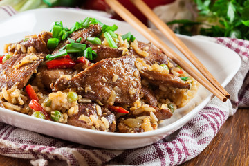 Fried rice with chicken and vegetables served on a plate