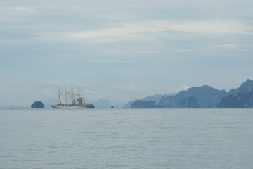 sailboat on the horizon white sails
