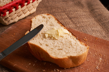 Bakery - gold rustic crusty loaves of bread and buns on black chalkboard background. Still life captured from above