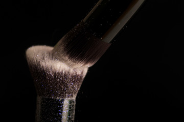 Cosmetics brush and colorful makeup powder