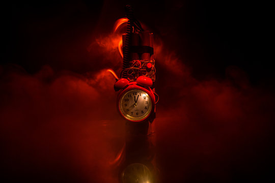 Image of a time bomb against dark background. Timer counting down to detonation illuminated in a shaft light shining through the darkness,