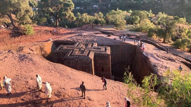 The rock-hewn monolithic Church of St. George at Lalibela, Ethiopia; visited by large group of tourists both local and international, December 2018, tc01
