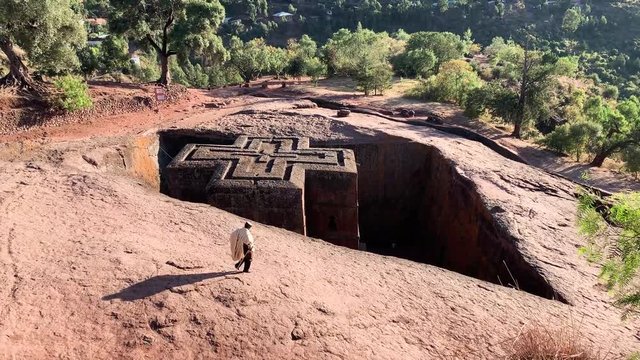 The rock-hewn monolithic Church of St. George at Lalibela, Ethiopia; visited by large group of tourists both local and international, December 2018, tc01