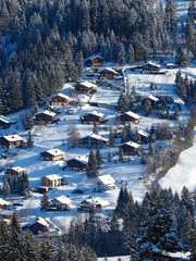 view on typical wooden houses in Swiss Alps near Schwarzsee lake, winter hike from Schwarzsee to Fuchses Schwyberg, Fribourg (Freiburg) canton, Switzerland, Europe