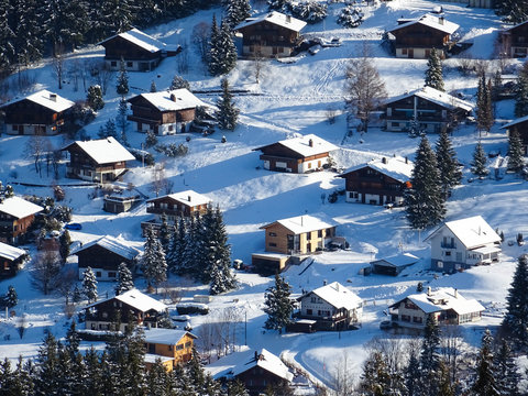 view on typical wooden houses in Swiss Alps near Schwarzsee lake, winter hike from Schwarzsee to Fuchses Schwyberg, Fribourg (Freiburg) canton, Switzerland, Europe