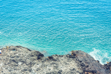 Rocky sea shore of Acitrezza next to Cyclops islands, Catania, Sicily, Italy.