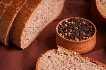 bowl of various pepper peppercorns seeds mix on table rastic style background