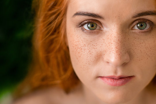 Beautiful young freckled green-eyed lady with red hair