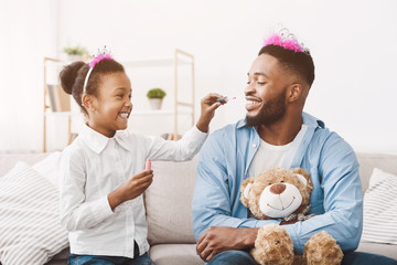 Funny time. Daughter doing makeup to her dad