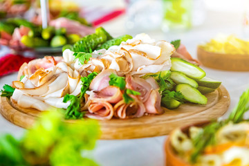 meal at the banquet. good cuts of meat, cheese. the holiday table