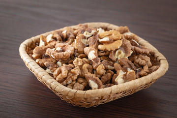 Fresh peeled walnuts in a rattan basket