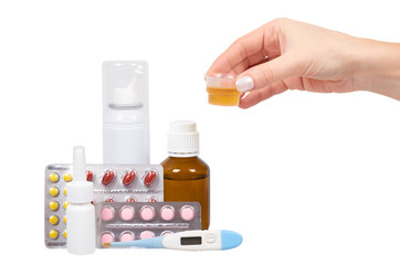 Bottle with medicine, nasal spray with hand. Antipyretic syrup and pills. Medication for cold...
