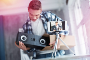 Blonde-haired student feeling happy after receiving big speakers for computers
