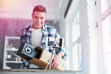 Handsome blogger making video opening his amazing birthday present