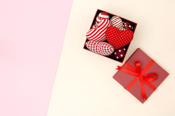 Flat lay of red pillows heart in gift box with copy space. Love and Valentine's day concept. Minimal style.