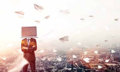Businessman with laptop instead of head.