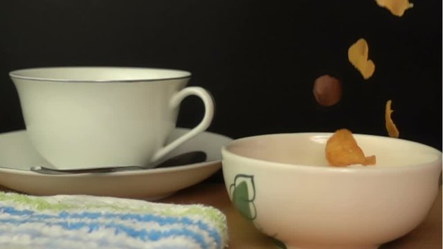 Pouring Cornflakes and Froot Loops into a white bowl for Breakfast Slow Motion