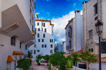 Fototapeta premium a Mediterranean city with white buildings on a blue sky