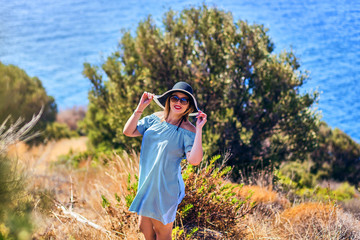 Beautiful woman in beach hat enjoying sea view with blue sky at sunny day in Bodrum, Turkey. Vacation Outdoors Seascape Summer Travel Concept