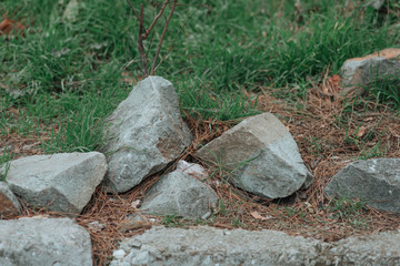 granite stones in green grass.