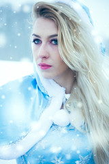 Beautiful young woman in winter snow