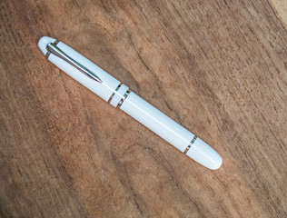 white single Luxury ball point pen with usb  on wooden background, business concept