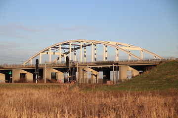 Steel suspension bridge on motorway A20 over the railroad tracks between Gouda, The Hague and Waddinxveen