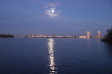 Full moon is rising above Nesselande beach reflecting on the Zevenhuizerplas as seen at Oud Verlaat just after sunset.