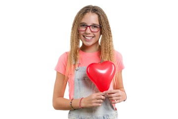 Young smiling teen girl congratulating on holiday with red heart balloon on isolated white background