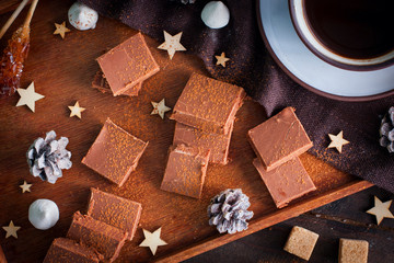 Homemade chocolate, sliced with a cup of coffee, top view, horizontal