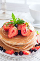 Summer breakfast with homemade punkakes of wholemeal flour and strawberries, selective focus
