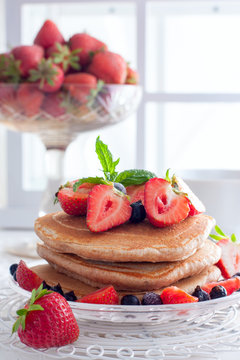 Breakfast with pankakes from whole wheat flour and fresh berries, selective focus