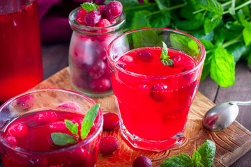 Cranberry juice from frozen cranberries on a wooden board, horizontal