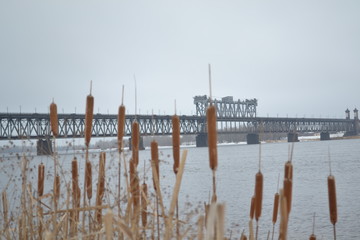  Dangerous bridge over the river. Winter