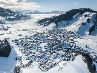 Aerial view of snow covered town in Switzerland. Rothenthurm village in winter.